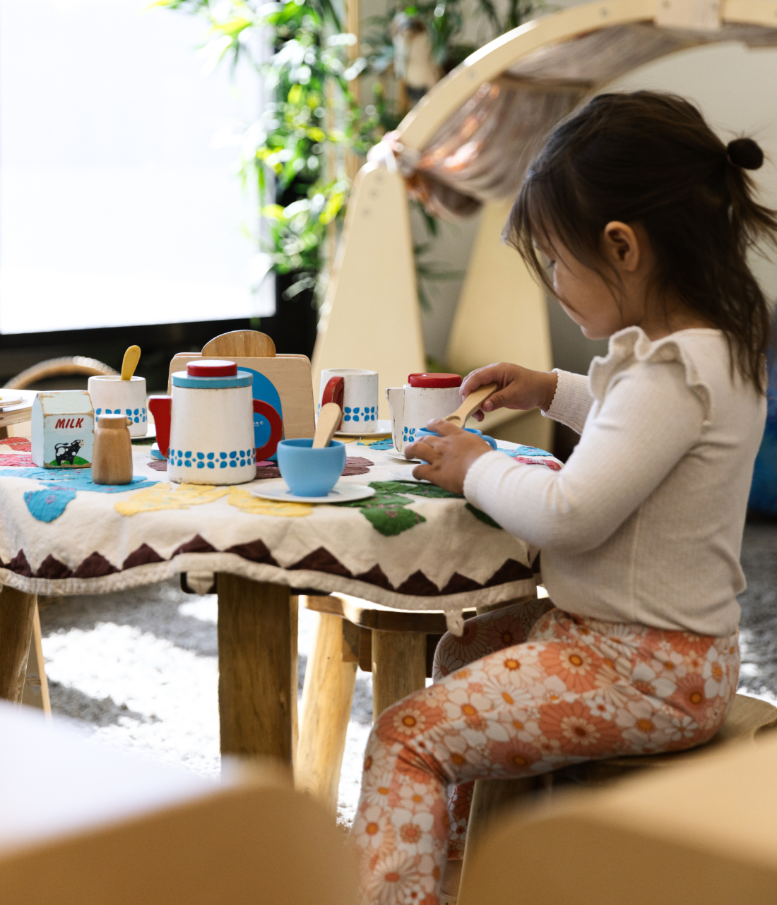 Children's play kitchen area with small furniture